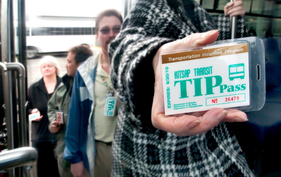 US Navy 100405-N-7111C-037 Workers at Puget Sound Naval Shipyard and Intermediate Maintenance Facility hold their TIP passes as they wait for transportation