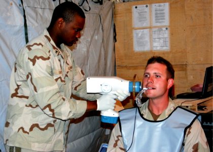 US Navy 100403-N-7062A-087 Hosptial Corpsman 3rd Class Adrian Eady performs a bitewing X-ray on Hospital Corpsman 2nd Class John Edstrom photo