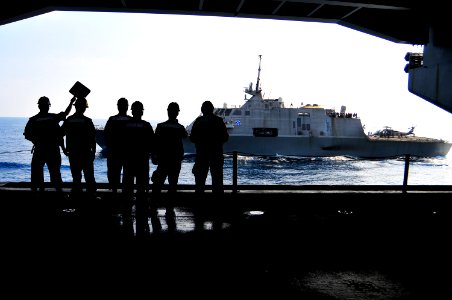 US Navy 100407-N-8878B-094 Sailors watch as the littoral combat ship USS Freedom (LCS 1) conducts a refueling at sea with the Nimitz-class aircraft carrier USS Carl Vinson (CVN 70) photo