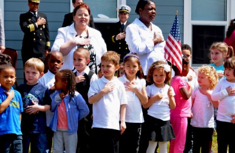 US Navy 100405-N-1831S-045 hildren enrolled in the Joint Expeditionary Base Little Creek - Fort Story Child Development Center Pre-School sing the National Anthem during a ribbon cutting ceremony for the 24-7 Child and Youth Ce