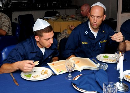 US Navy 100405-N-1082Z-095 Lt. David J. Jeltema and Boatswain's Mate Seaman Michael A. Stone read from the Haggadah, the religious text that sets out the order of the Passover Seder