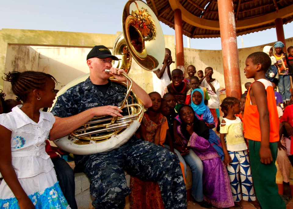 US Navy 100408-N-6138K-207 Musician 1st Class Roger Starcher performs for more than 300 children at the Colin Powell Cultural Center