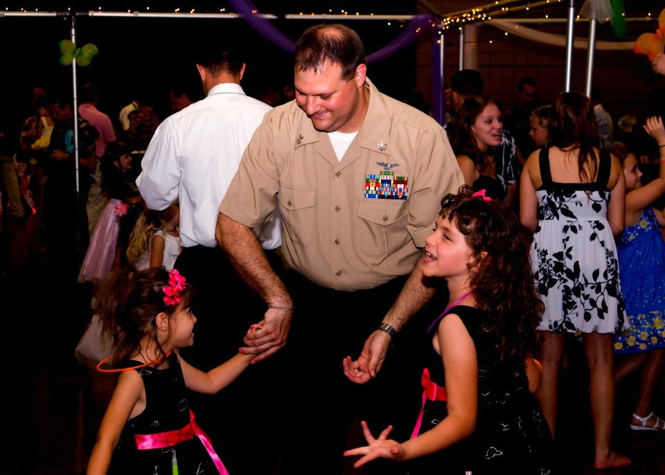US Navy 100403-N-6674H-003 Aircrew Survival Equipmentman 1st Class Jeremy Simon, assigned to Pearl Harbor Naval Shipyard, dances with his daughters