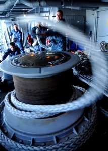 US Navy 100408-N-7908T-058 Seaman Joseph M. Richardson, assigned to the deck department's 3rd Division, unravels line from a capstan on the fantail of the aircraft carrier USS George H.W. Bush (CVN 77)