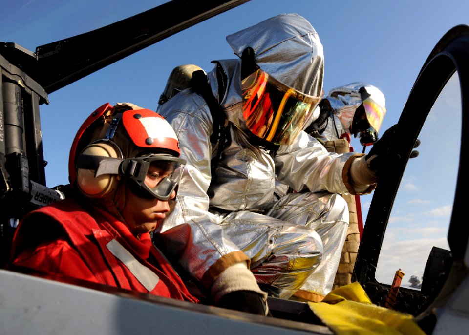 US Navy 100403-N-3885H-092 Members of the air department crash and salvage team aboard the aircraft carrier USS George H.W. Bush (CVN 77) practice rescuing a pilot during a drill on the flight deck