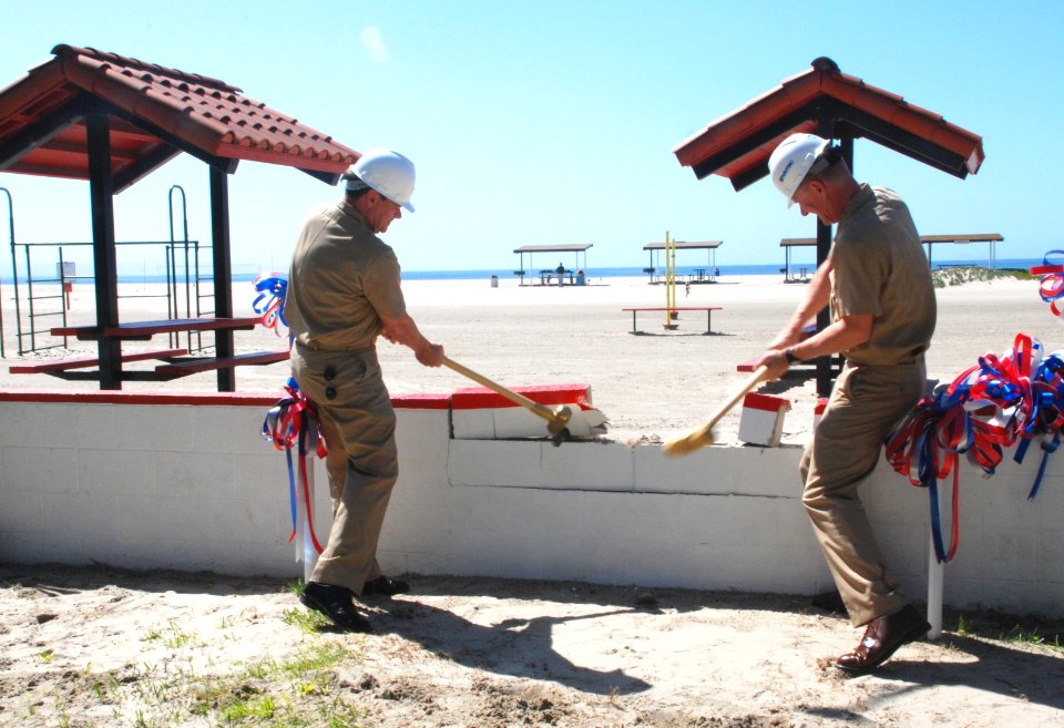 US Navy 100406-N-1926C-145 apt. Ed Spillman and Capt. Yancy Lindsey demolish a wall at the site of the new Navy Lodge renovation project at Naval Air Station North Island