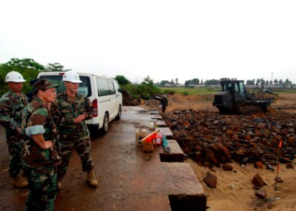 US Navy 100403-N-6138K-792 Capt. Cindy Thebaud, commander of Africa Partnership Station West, tours the Armed Forces of Liberia Coast Guard Base in Monrovia with U.S. Navy Lt. Aaron Allison from Austin, Texas, and Chief Builder