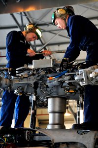 US Navy 100406-N-7364R-024 Aviation Machinist's Mate 2nd Class Scott Lister, left, and Aviation Machinist's Mate 3rd Class Jason McConell perform maintenance on the main rotor head of an MH-60S Sea Hawk helicopter