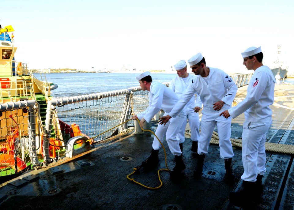 US Navy 100405-N-9301W-030 Sailors aboard the guided-missile frigate USS Klakring (FFG 42) take a line from a tugboat to get the ship underway