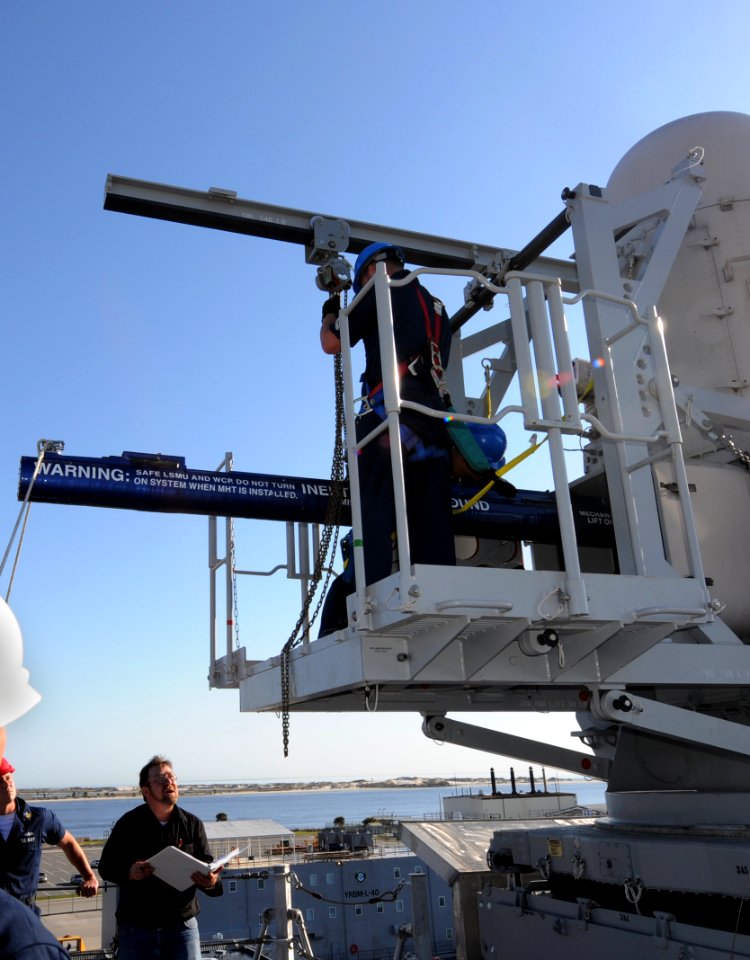 US Navy 100406-N-7653W-094 Sailors and civilian personnel aboard the littoral combat ship USS Independence (LCS 2) hoist a training round into the Sea Rolling Air Frame Missile (SEARAM) launcher