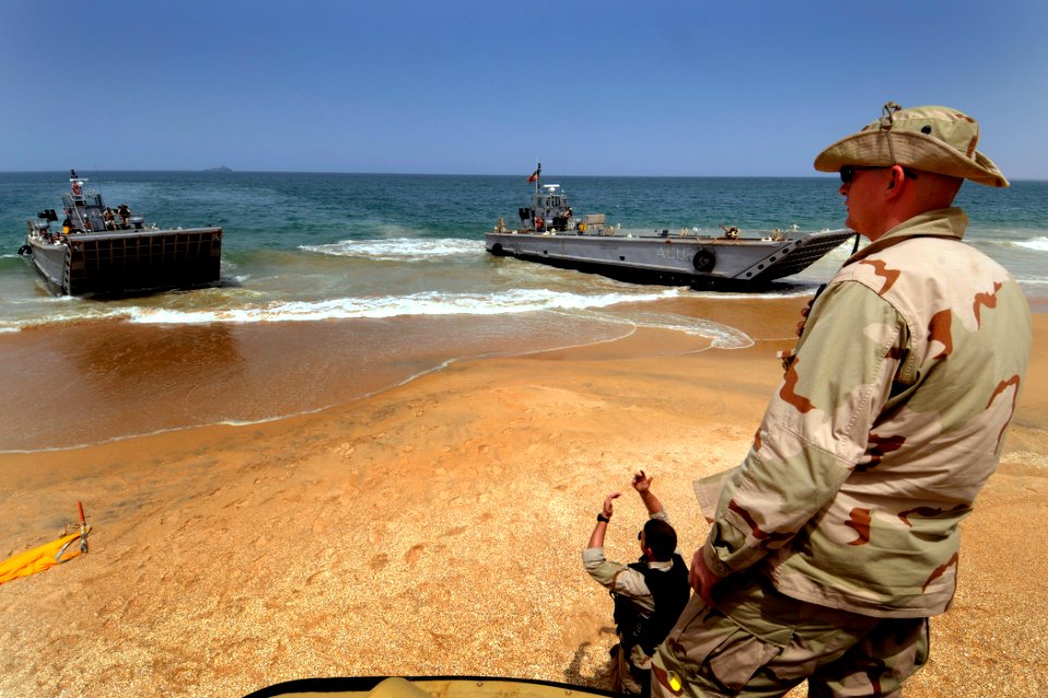 US Navy 100406-N-7948C-419 Gunner's Mate 2nd Class Michael Magrames watches the offload of U.S, Spanish, Portuguese and British marines