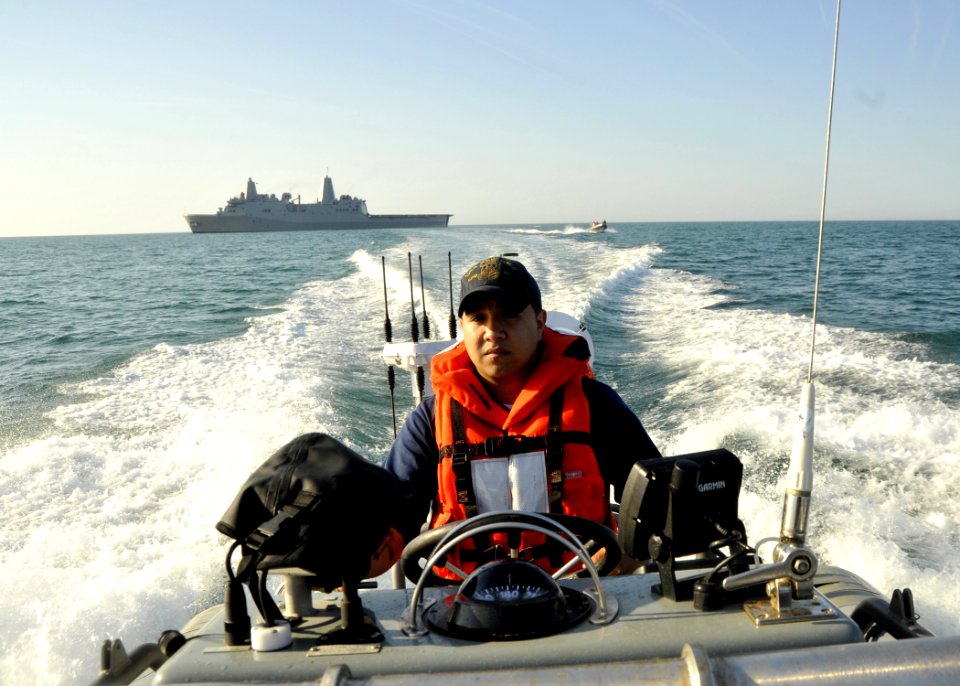 US Navy 100412-N-2147L-002 Boatswain's Mate Seaman Gaspar Ramos departs the amphibious transport dock ship USS New York (LPD 21) in a rigid-hull inflatable boat to escort amphibious assault vehicles from the U.S. Marine 2nd Ass