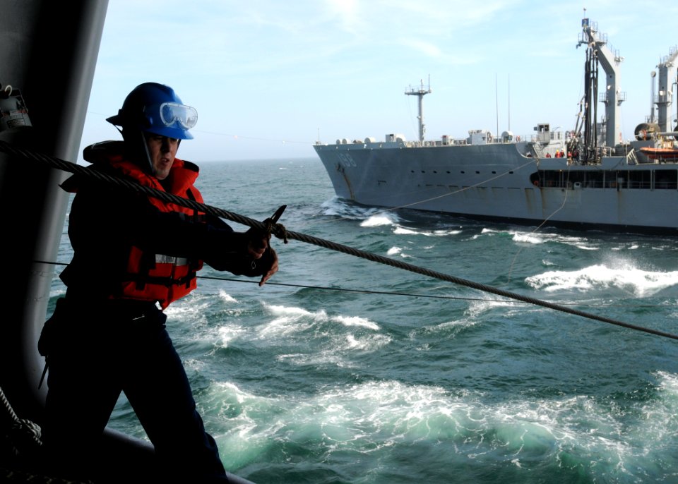 US Navy 100407-N-9116S-279 Boatswain's Mate 3rd Class Stephen J. Markman removes the stopper line during an underway replenishment