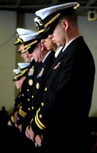 US Navy 100407-N-4236E-231 Officers bow their heads aboard the aircraft carrier USS Dwight D. Eisenhower (CVN 69) during a memorial service for Lt. Steven Zilberman