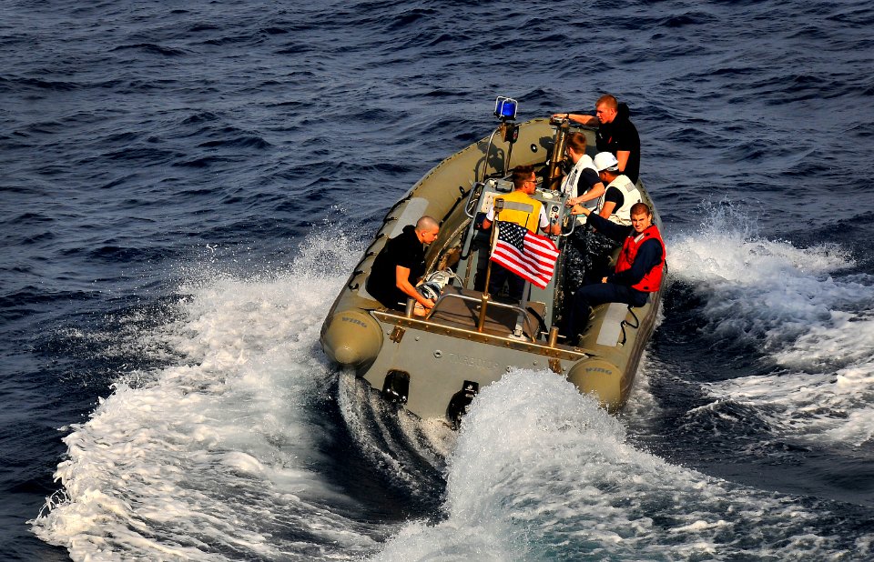 US Navy 100409-N-4774B-032 ailors assigned to the guided-missile cruiser USS Bunker Hill (CG 52) use a rigid-hull inflatable boat to recover an exercise torpedo during a test of the torpedo launch system
