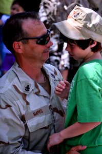 US Navy 100413-N-7367K-004 Senior Chief Hull Maintenance Technician Don Mapes hugs his son during the battalion's homecoming at the training hall at Naval Construction Battalion Center, Gulfport
