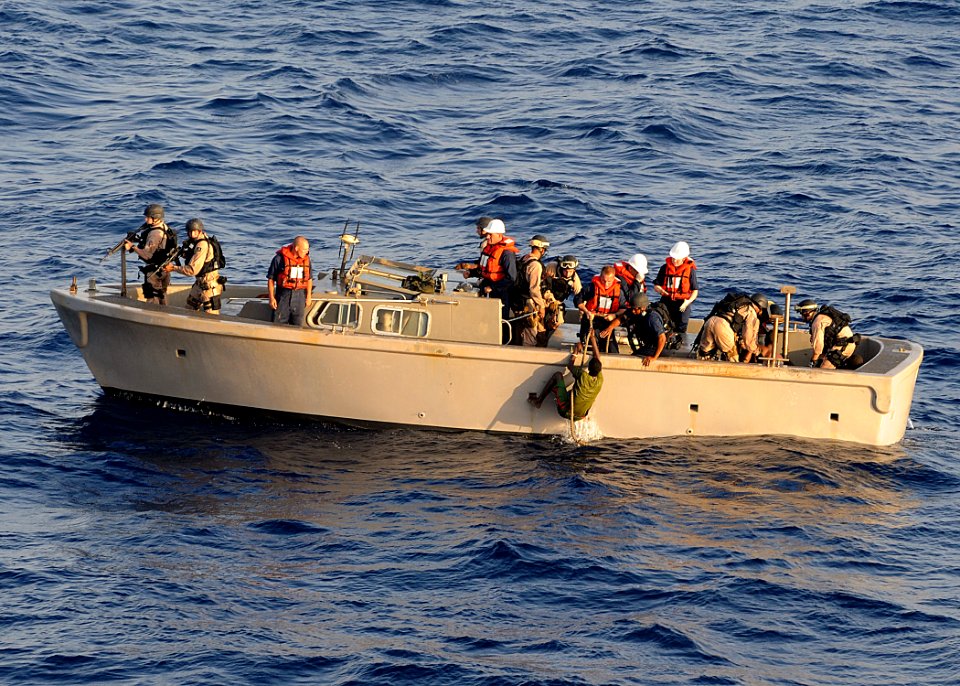 US Navy 100410-N-1082Z-119 A visit, board, search and seizure (VBSS) team pulls suspected pirates from the sea for transport back to the amphibious dock landing ship USS Ashland (LSD 48)