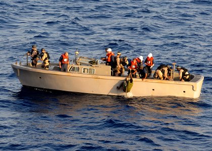 US Navy 100410-N-1082Z-119 A visit, board, search and seizure (VBSS) team pulls suspected pirates from the sea for transport back to the amphibious dock landing ship USS Ashland (LSD 48)