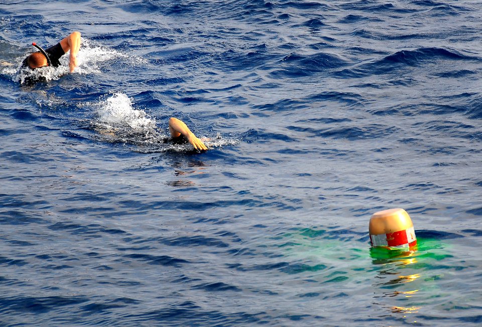 US Navy 100409-N-4774B-065 Search and Rescue swimmers from the guided-missile cruiser USS Bunker Hill (CG 52) recover an exercise torpedo during a test of the torpedo launch system