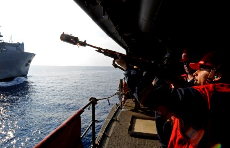US Navy 100414-N-7280V-460 Fire Controlman 3rd Class Ivan Galvez, assigned to the U.S. 7th Fleet command ship USS Blue Ridge (LCC 19), fires a shot-line during a replenishment at sea
