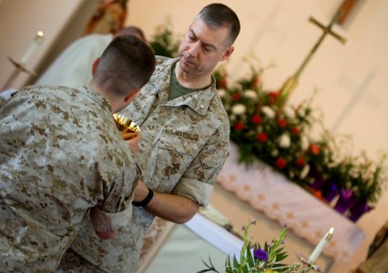 US Navy 100412-N-7090S-290 Marines assigned to Marine Corps Base Quantico, Va., drink from a cup that represents the blood of Christ during a Catholic Mass photo