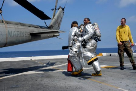 US Navy 100415-N-3358S-011 Aviation Boatswain's Mate (Handling) 1st Class Bradley Grayson supervises sailors during a fire drill aboard the amphibious transport dock ship USS Mesa Verde (LPD 19)