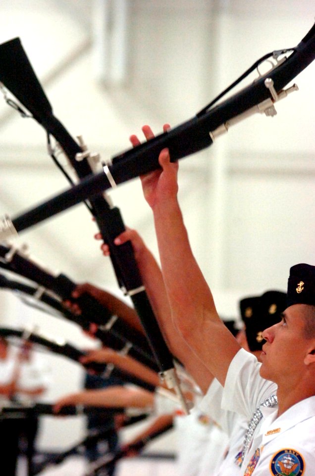 US Navy 100411-N-4482V-007 lour Bluff High School (Corpus Christi, Texas) cadets compete in the armed platoon exhibition during the second day of the Navy Junior ROTC national competition