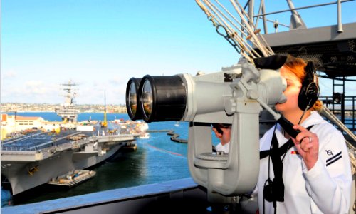 US Navy 100412-N-8822R-107 Operations Specialist Seaman Apprentice Katie Aldridge, from San Antonio, Texas, looks through binoculars
