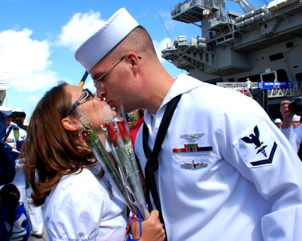 US Navy 100412-N-1926C-158 Hospital Corpsman 3rd Class Daniel Steven Harris, assigned to the aircraft carrier USS Carl Vinson (CVN 70), kisses his wife after arriving at Naval Air Station North Island