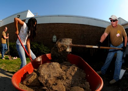 US Navy 100415-N-4267W-064 Chief Engineman Raymond Valadez, right, assigned to Navy Expeditionary Combat Command (NECC), and a student from Bayside Middle School in Virginia Beach dig a path for excess rainwater