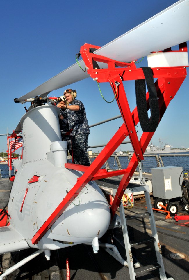 US Navy 100416-N-0486G-002 Aviation Machinist's Mate 2nd Class Scott Schinke removes a main rotor blade from one of two MQ-8B Fire Scout UAVs