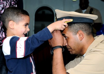 US Navy 100415-N-8913A-022 Ensign Mostafa Rashed's son places his combination cover during his commissioning ceremony aboard the aircraft carrier USS George H.W. Bush (CVN 77)