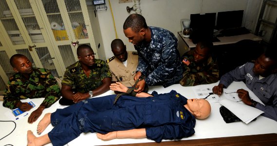 US Navy 100416-N-6676S-002 Hospital Corpsman 1st Class Jason Ashmeade, center, from Long Island, N.Y., demonstrates to service members from the Senegal, Liberia, Sierra Leone, Gambia and Equatorial Guinea armed forces the prope photo