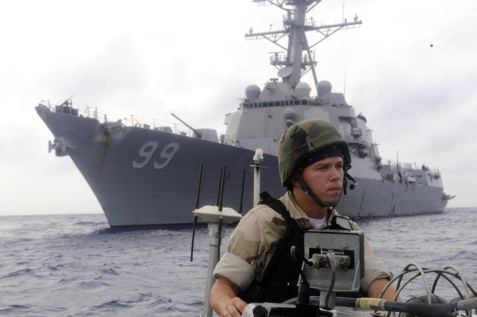 US Navy 100415-N-8959T-185 Boatswains Mate Seaman Kelly P. Chism, assigned to the Arleigh Burke-class guided-missile destroyer USS Farragut (DDG 99), drives a visit, board, search and seizure team towards a suspected pirate ves