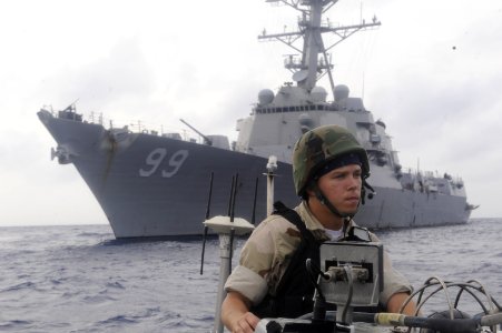 US Navy 100415-N-8959T-185 Boatswains Mate Seaman Kelly P. Chism, assigned to the Arleigh Burke-class guided-missile destroyer USS Farragut (DDG 99), drives a visit, board, search and seizure team towards a suspected pirate ves photo