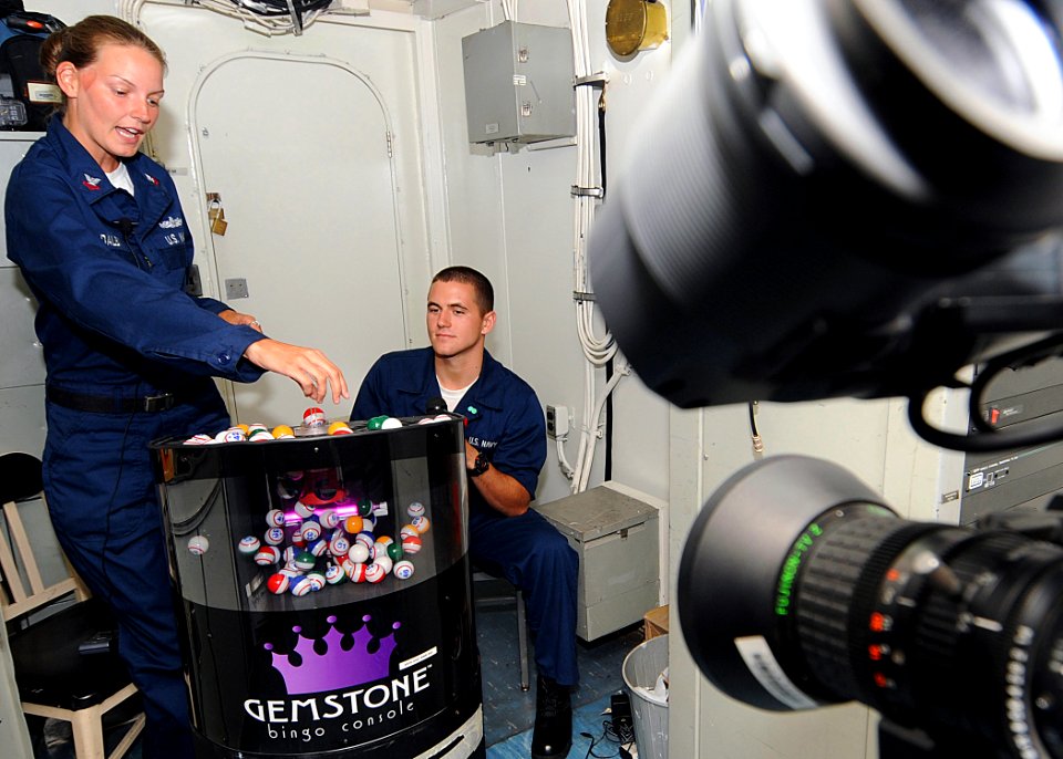 US Navy 100416-N-1082Z-051 Boatswain's Mate 2nd Class Kelli D. Dalby, from Stafford, Va., and Boatswain's Mate Seaman Mathew A. Parsons, from Ellerbe, N.C., announce numbers during a live Bingo game aboard the amphibious dock l