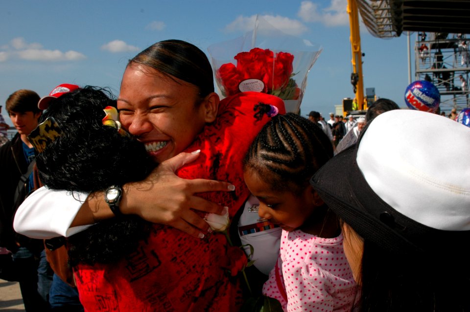 US Navy 100414-N-1261R-003 A sailor assigned to the amphibious assault ship USS Bonhomme Richard (LHD 6) is greeted by family members during a homecoming celebration