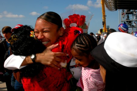 US Navy 100414-N-1261R-003 A sailor assigned to the amphibious assault ship USS Bonhomme Richard (LHD 6) is greeted by family members during a homecoming celebration