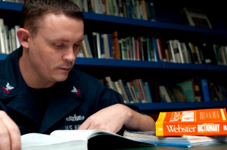 US Navy 100414-N-5712P-042 Hospital Corpsman 2nd Class Jason Snider, from Brownsburg, Ind., studies in the library aboard the amphibious assault ship USS Nassau (LHA 4) photo