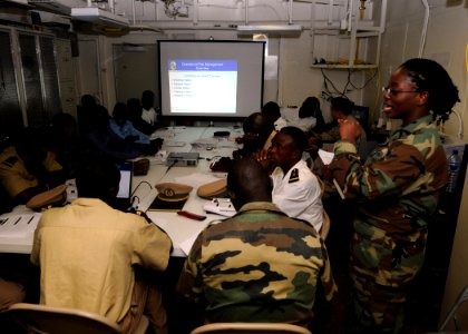 US Navy 100413-N-6676S-003 Operations Specialist 3rd Class Chirstelle Byll, right, from Baltimore, assigned to the Security Force Assistance Mobile Training Team photo