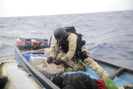 US Navy 100415-N-8959T-060 Master-at-Arms 1st Class Daniel Fuentes, a member of the Arleigh Burke-class guided-missile destroyer USS Farragut (DDG 99) visit, board, search and seizure team photo