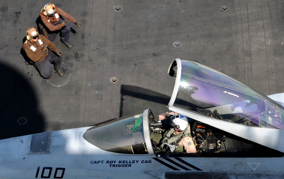 US Navy 100415-N-4236E-175 ailors direct the pilot of an F-A-18E Super Hornet assigned to the Pukin Dogs of Strike Fighter Squadron (VFA) 143 aboard the aircraft carrier USS Dwight D. Eisenhower (CVN 69)