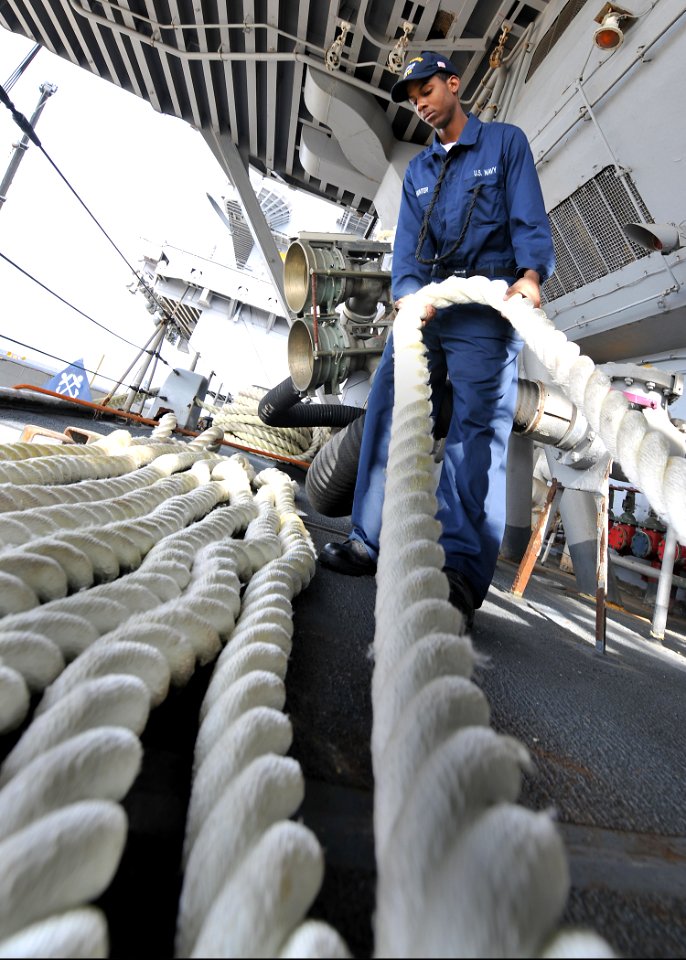 US Navy 100420-N-5082P-105 Boatswain's Mate Seaman Troy B. Hunter slacks out line aboard the aircraft carrier USS Enterprise (CVN 65)