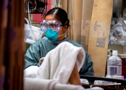 USNS Mercy Sailor Treats Patient (49758476567)