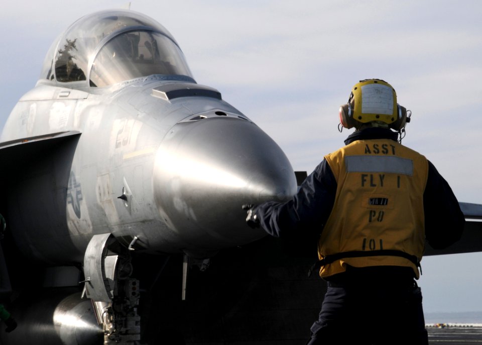 US Navy 100420-N-6509M-083 A Sailor assigned to the air department of the aircraft carrier USS George H.W. Bush (CVN 77) directs an F-A-18F Super Hornet