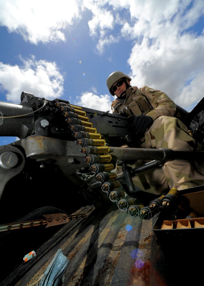 US Navy 100421-N-4965F-251 Master-at-Arms 3rd Class Nicole Gann, assigned to Maritime Expeditionary Security Squadron (MSRON) 3, guards an entry control point with a .50-caliber machine gun at a simulated forward operating base