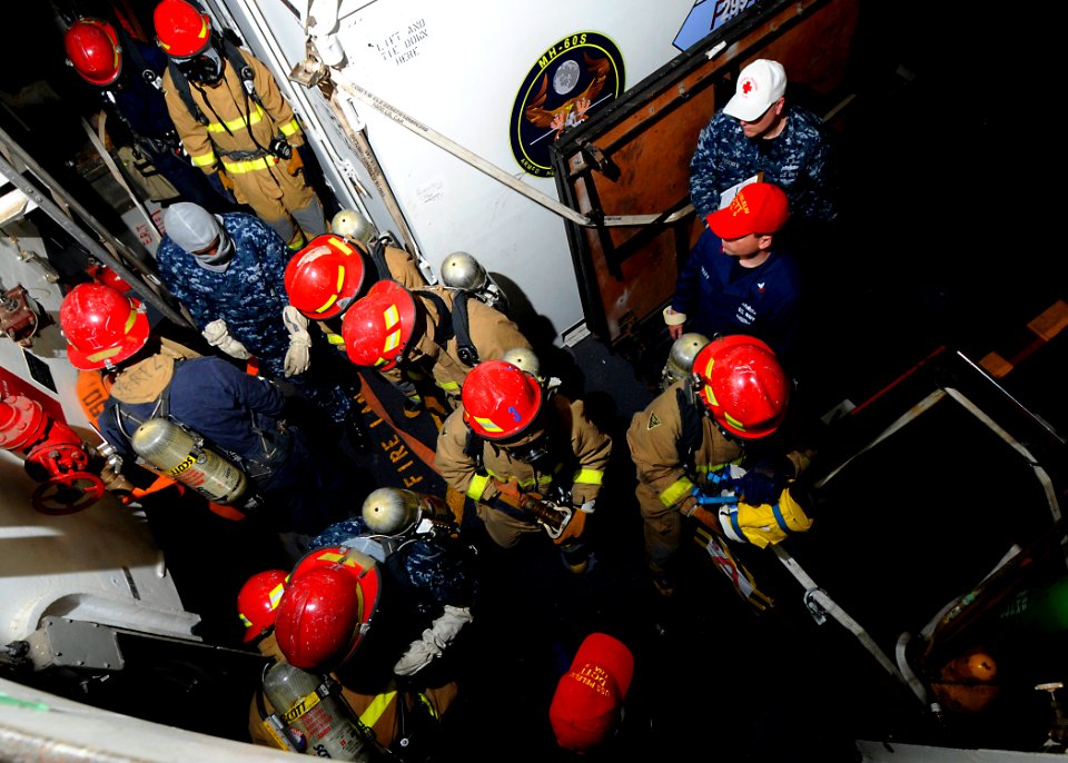 US Navy 100417-N-7948R-201 Sailors man a fire hose during a general quarters drill aboard the amphibious assault ship USS Peleliu (LHA 5)