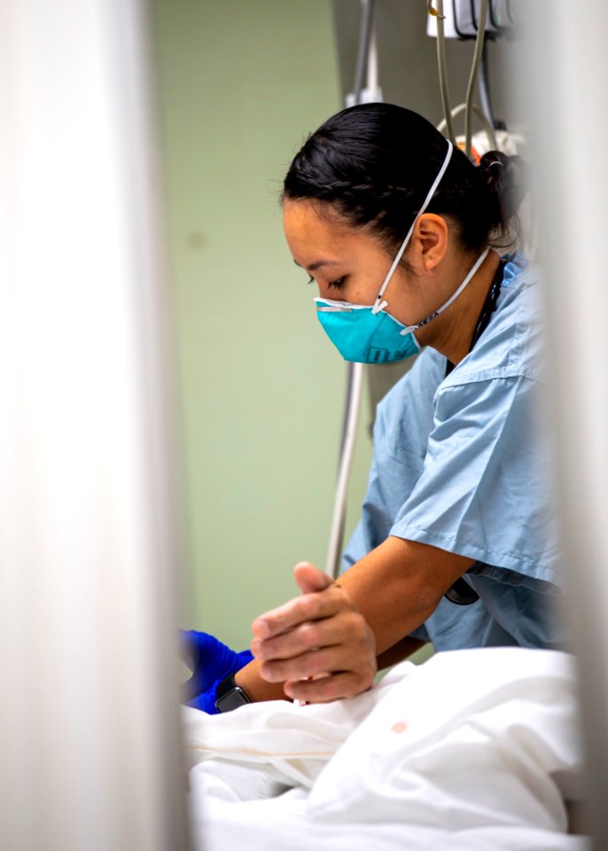 USNS Mercy Sailor Treats Patient (49785699941)
