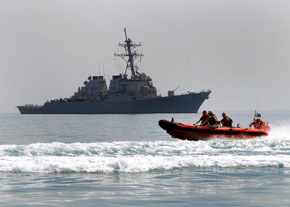 US Navy 100419-N-1082Z-131 A U.S. Coast Guard rigid-hull inflatable boat passes near the guided-missile destroyer USS The Sullivans (DDG 68)