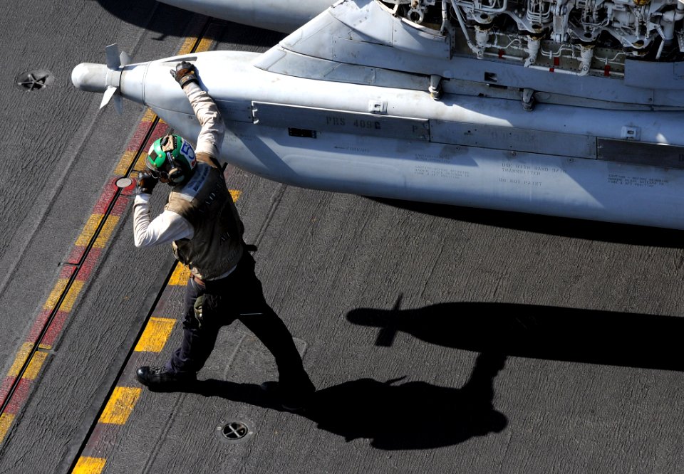 US Navy 100417-N-4236E-205 A Sailor walks next to an EA-6B Prowler assigned to the Patriots of Electronic Attack Squadron (VAQ) 140 aboard the aircraft carrier USS Dwight D. Eisenhower (CVN 69)